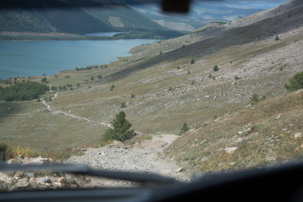 Looking down a the winding road with lake in the background 